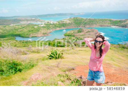 Young woman enjoying breathtaking views of beautiful landscape Young woman enjoying breathtaking views of beautiful landscape 58546859