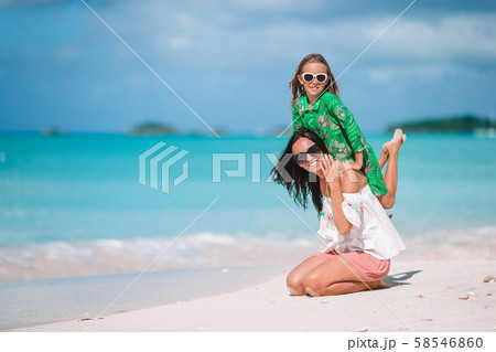 Beautiful mother and daughter on Caribbean beach Beautiful mother and daughter on Caribbean beach 58546860