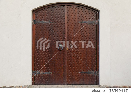 Old dark wooden arched gates 58549417