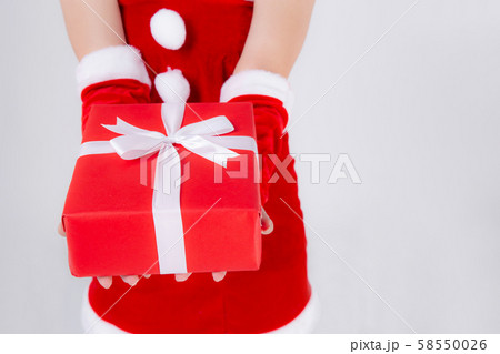 Closeup hand woman holding present box in xmas day with surprise isolated 58550026