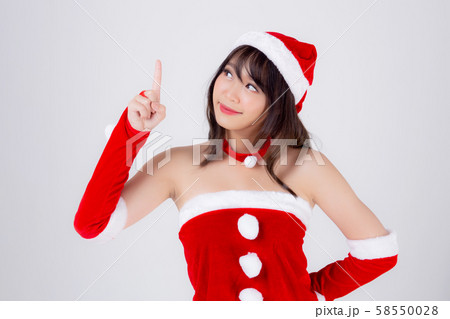 Beautiful portrait young asian woman Santa costume smiling present pointing something 58550028