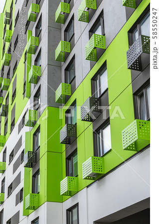 Vibrant green wall of new apartment building 58550247
