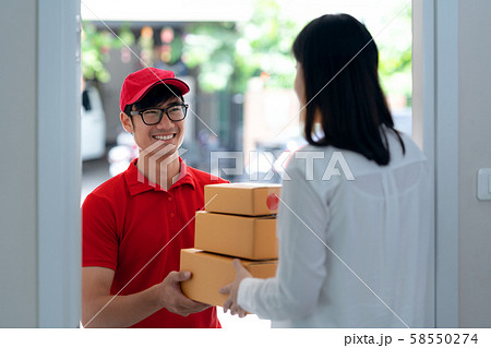 Asian girl recieve a box from online shopping from 58550274