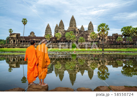 Asian monk stand and look to Angkor wat in siem Asian monk stand and look to Angkor wat in siem 58550724