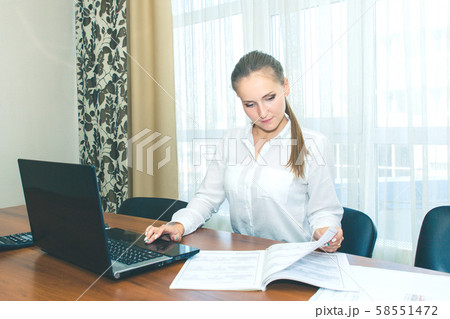 The girl in the workplace in the office with a 58551472