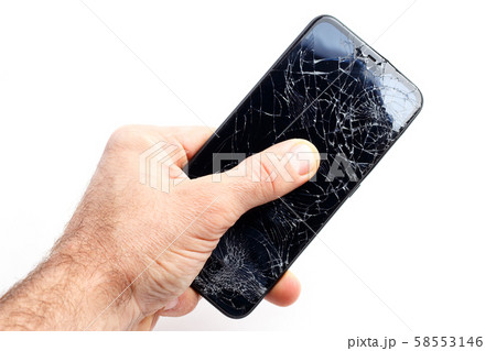 Hand holds a broken smartphone on a white background Hand holds a broken smartphone on a white background 58553146