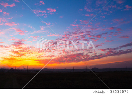 sunset in the cloudy sky above the industrial city 58553673
