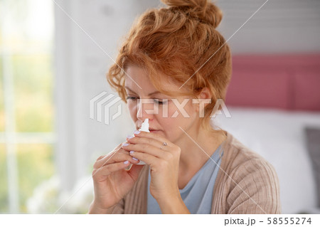 Woman having terrible day while suffering from stuffy nose 58555274