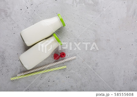 Kefir drink with raspberry on the gray background Kefir drink with raspberry on the gray background 58555608