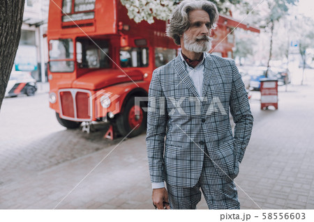 Attractive man in suit standing in the street stock photo 58556603
