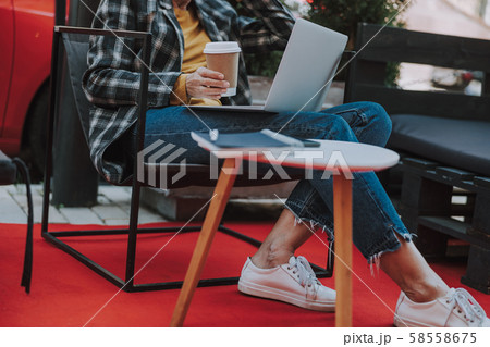 Lady sitting in front of her laptop Lady sitting in front of her laptop 58558675