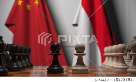 Chess game against flags of China and Indonesia. Political competition related 3D rendering Chess game against flags of China and Indonesia. Political competition related 3D rendering 58558895