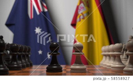 Chess game against flags of Australia and Spain. Political competition related 3D rendering Chess game against flags of Australia and Spain. Political competition related 3D rendering 58558927