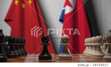 Flags of China and North Korea behind pawns on the chessboard. Chess game or political rivalry 58559027