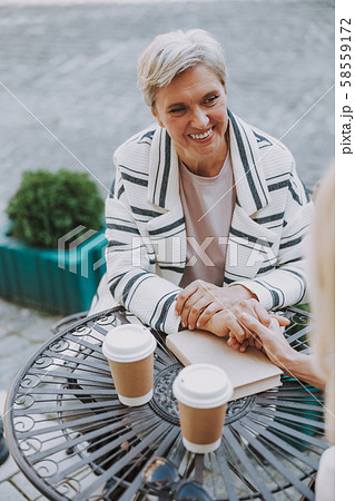 Cheerful attractive lady holding her friends hand 58559172