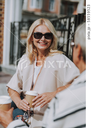 Cheerful woman looking at her female friend Cheerful woman looking at her female friend 58559523