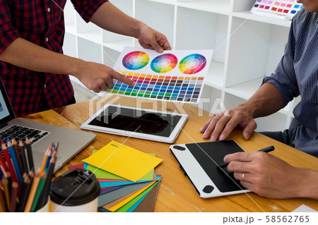 Graphic designers present colors from the color palette to their friends, for creative design ideas. Graphic designers present colors from the color palette to their friends, for creative design ideas. 58562765