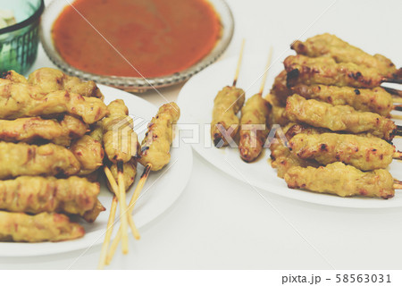 Pork satay with peanut sauce at street food market 58563031