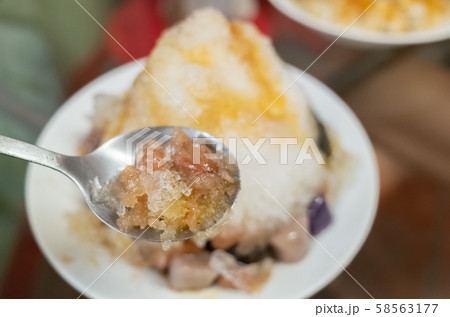 eating shaved ice with colorful dessert 58563177