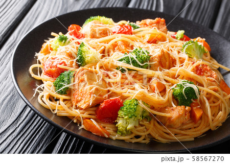 Tasty pasta with chicken and vegetables close-up 58567270