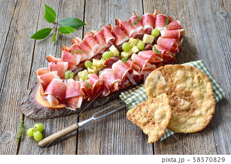 South Tyrolean snack with bacon, salami and aged mountain cheese, served with local crunchy bread South Tyrolean snack with bacon, salami and aged mountain cheese, served with local crunchy bread 58570829