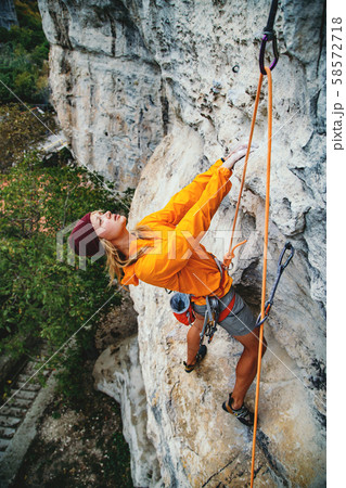 Girl climbing a rock. Girl climbing a rock. 58572718