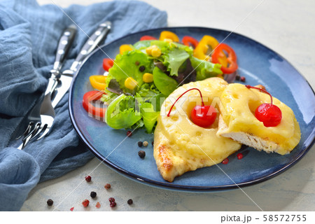 Sweet baked chicken escalope with pineapple slices and melted cheese 58572755