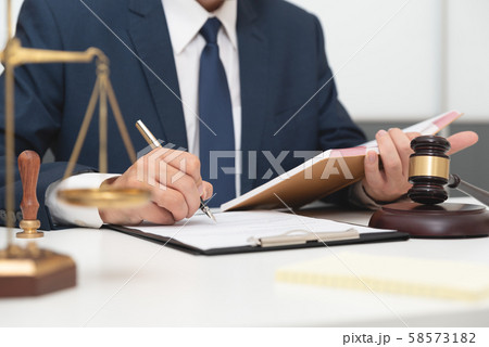 Lawyer or attorney working with papers in office Lawyer or attorney working with papers in office 58573182