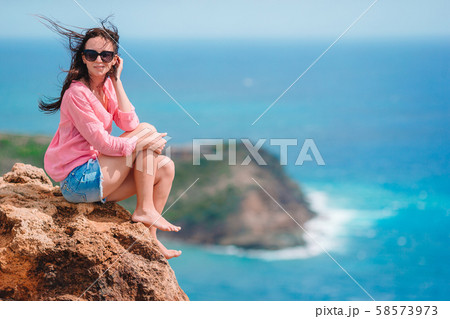 Young woman enjoying breathtaking views of beautiful landscape Young woman enjoying breathtaking views of beautiful landscape 58573973