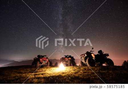 Atv quad motorbikes in the mountains under night starry sky 58575185