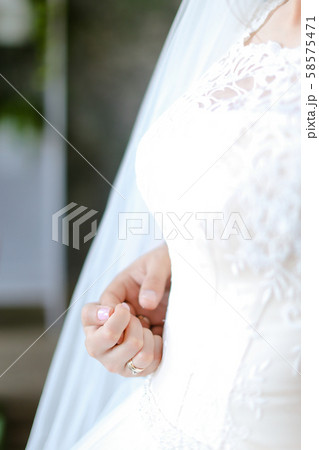 Closeup bridal dress and hand. Closeup bridal dress and hand. 58575471