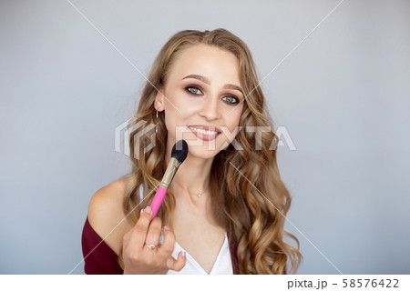 Cosmetics for beauty. Cosmetics. Close-up of a beautiful young woman with glamorous eye makeup Cosmetics for beauty. Cosmetics. Close-up of a beautiful young woman with glamorous eye makeup 58576422