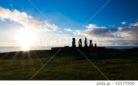 Moais in Ahu Tahai at sunset with sun in the horizon 58577000