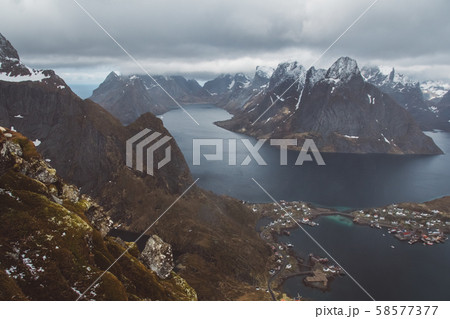 Scenic landscape of Lofoten islands: peaks, lakes, and houses. Reine village, rorbu, reinbringen 58577377