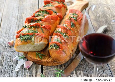 Spanish food: Roasted bread with herb butter and hot Chorizo salami served with a tempranillo wine 58578537