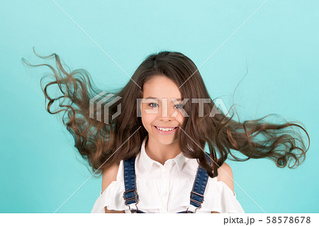 Girl with blowing long healthy brunette hair 58578678