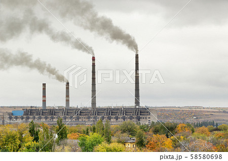 Air pollution concept. Thermal power station building with smokestacks with clouds of smoke against 58580698