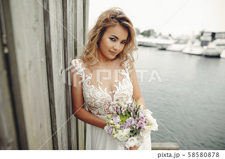 Elegant bride near water Elegant bride near water 58580878