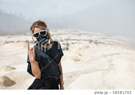 Women in protective filter mask walking around 58581702