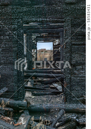 View from the window of a burnt wooden destroyed house in the cemetery. Mystical place. Vertical 58583431