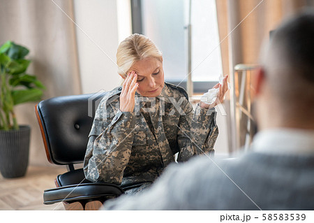 Servicewoman holding napkin and talking to psychoanalysis 58583539