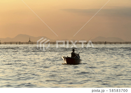 fisherman silhouette at Sunset in Venice lagoon fisherman silhouette at Sunset in Venice lagoon 58583700