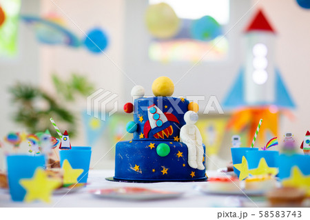 Kids space theme birthday party with cake. 58583743