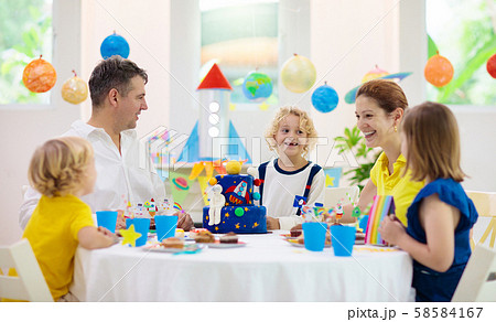 Kids space theme birthday party with cake. Kids space theme birthday party with cake. 58584167