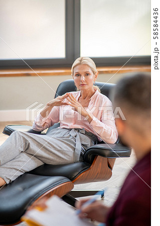Woman sitting and speaking with young psychoanalyst 58584436