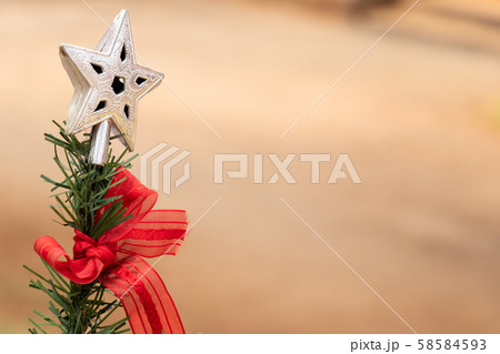 Silver decoration star on green christmas tree Silver decoration star on green christmas tree 58584593