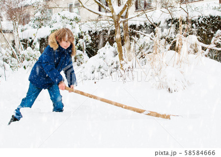 Child shoveling winter snow. Kids clear driveway. Child shoveling winter snow. Kids clear driveway. 58584666