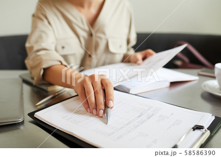 Woman working with financial report Woman working with financial report 58586390