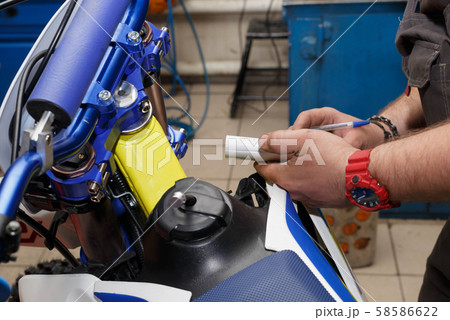 The master in the service writes the data to the motorcycle service book. The master in the service writes the data to the motorcycle service book. 58586622