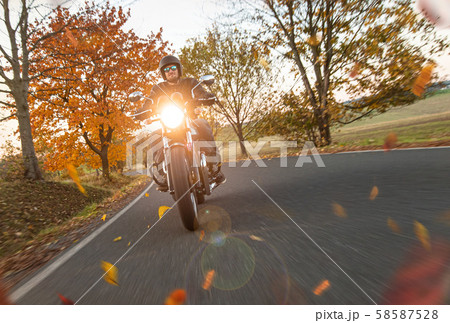 Moto racer riding on mountain road, travel to Europe. 58587528